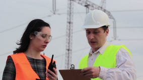 Teamwork two specialist for high voltage. Supervisor and engineer for electric power considered plans for electrifying and notifies using walkie-talkie,video Teamwork two specialist for high voltage. Supervisor and engineer for electric power considered plans for electrifying and notifies using walkie-talkie,video