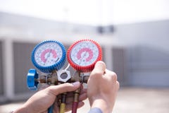 Technician is checking air conditioner ,measuring equipment for filling air conditioners royalty free stock photos Technician is checking air conditioner ,measuring equipment for filling air conditioners royalty free stock photos