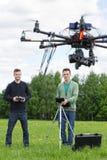 Technicians Flying UAV Helicopter in Park royalty free stock image Technicians Flying UAV Helicopter in Park royalty free stock image