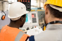 Technicians Studying Operating Manual royalty free stock photography Technicians Studying Operating Manual royalty free stock photography