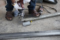 Technicians use metal pipe drilling machines stock photo Technicians use metal pipe drilling machines stock photo