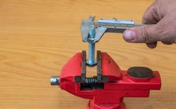 Bolt diameter measurement technology using calipers royalty free stock photo Bolt diameter measurement technology using calipers royalty free stock photo