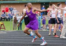 Teen Boy Accepts Baton at Outdoor Track and Field Meet royalty free stock photo Teen Boy Accepts Baton at Outdoor Track and Field Meet royalty free stock photo