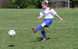 Teen Girl Soccer Player In Action Stock Photography