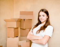 Teen girl standing on a background of cardboard stock photography Teen girl standing on a background of cardboard stock photography
