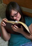 Teen Reads Bible In Her Room Stock Photos