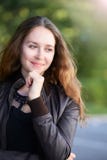 Teen young woman serene outside. think up. hold chin. casual dress. people face stock photography Teen young woman serene outside. think up. hold chin. casual dress. people face stock photography
