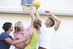 Teenage Family Playing Basketball Outside Garage royalty free stock photo Teenage Family Playing Basketball Outside Garage royalty free stock photo