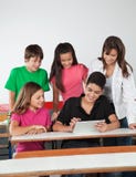 Teenage Friends Using Digital Tablet At Desk Stock Photography Teenage Friends Using Digital Tablet At Desk Stock Photography