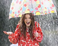 Teenage Girl Sheltering From Rain Beneath Umbrella Stock Images Teenage Girl Sheltering From Rain Beneath Umbrella Stock Images