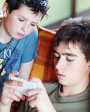 Teenager Boys Playing On Smartphone, Outdoor Stock Image