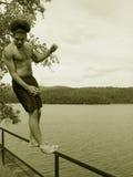 Teenager Falling Backward By A Lake Royalty Free Stock Photos