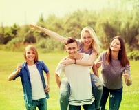 Teenagers running on green lawn in park stock images Teenagers running on green lawn in park stock images
