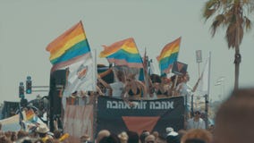 TEL AVIV, Israel, am 9. Juni 2017 Leute, die die rianbow Flagge in der jährlichen Stolzparade tanzen, marschieren und wellenartig stock footage TEL AVIV, Israel, am 9. Juni 2017 Leute, die die rianbow Flagge in der jährlichen Stolzparade tanzen, marschieren und wellenartig stock footage