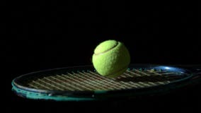 Tennis ball bouncing on a racket