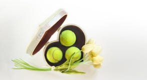 Tennis Love Layout Tennis Balls In Box In Shape Of Heart With Bouquet White Tulips On White Background. Women`s Day March 8. Copy Stock Photo