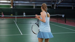 Tennislek Ung flicka som spelar mot två unga spelare Övning i tennis stock video Tennislek Ung flicka som spelar mot två unga spelare Övning i tennis stock video