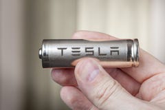 Tesla 2170 Battery lithium ion Cells pack, in human hand. stock photography Tesla 2170 Battery lithium ion Cells pack, in human hand. stock photography