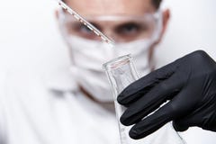 A test tube with a falling drop in a glass flask stock photography A test tube with a falling drop in a glass flask stock photography