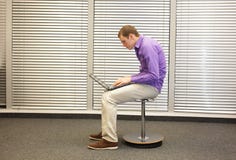 Text neck - man in slouching position working with computer stock photos Text neck - man in slouching position working with computer stock photos