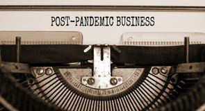 Text `post-pandemic business` typed on retro typewriter. Business and post-pandemic covid-19 concept