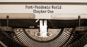 Text `post-pandemic world chapter one` typed on retro typewriter. Business and post-pandemic covid-19 concept. Sepia effect