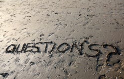 Text QUESTIONS with question mark written on the sand royalty free stock photo Text QUESTIONS with question mark written on the sand royalty free stock photo