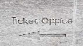 Text ticket office with arrow on wooden panel. Text ticket office with arrow on grey wooden panel stock photos Text ticket office with arrow on wooden panel. Text ticket office with arrow on grey wooden panel stock photos