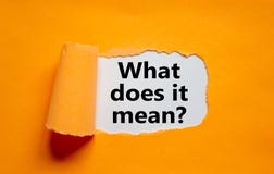 The text `what does it mean` appearing behind torn orange paper. Business concept, copy space