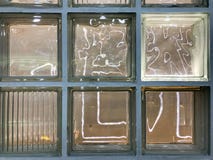 The texture of a beautiful glass carved glowing transparent square square of large decorative tiles with different patterns. The b stock photo The texture of a beautiful glass carved glowing transparent square square of large decorative tiles with different patterns. The b stock photo