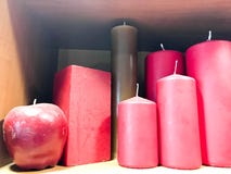Texture of many festive different forms of red, burgundy wax candles with wicks standing in a row. The background stock photography Texture of many festive different forms of red, burgundy wax candles with wicks standing in a row. The background stock photography