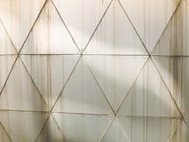 Texture of metal industrial iron white wall of triangular plates with seams with patterns in the style triangulation with rivets royalty free stock image Texture of metal industrial iron white wall of triangular plates with seams with patterns in the style triangulation with rivets royalty free stock image
