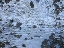 Texture of the old gray concrete cement plastered wall with cracks dent in holes patterns and divorce, splintered pieces and white Stock Image Texture of the old gray concrete cement plastered wall with cracks dent in holes patterns and divorce, splintered pieces and white Stock Image