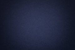 Texture of old navy blue paper background, closeup. Structure of dense cardboard