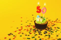 50th birthday cupcake with candle and sprinkles