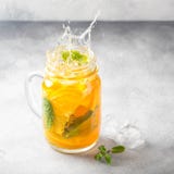 Th? froid avec l'orange, la menthe et la glace, boisson douce d'?t?, limonade r?g?n?ratrice, cocktail juteux Jet, ?claboussure photographie stock Th? froid avec l'orange, la menthe et la glace, boisson douce d'?t?, limonade r?g?n?ratrice, cocktail juteux Jet, ?claboussure photographie stock