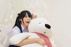 Thai High School Girl In Glasses Show Shocking Expression While Hugging Teddy Bear Royalty Free Stock Images Thai High School Girl In Glasses Show Shocking Expression While Hugging Teddy Bear Royalty Free Stock Images