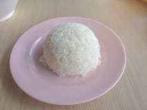 Thai jasmine rice cooked in a plate on a wooden table royalty free stock photos Thai jasmine rice cooked in a plate on a wooden table royalty free stock photos