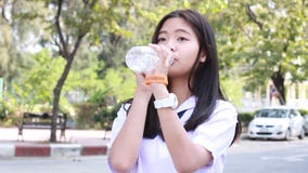 Thai student teen beautiful girl give drinking water stock video footage Thai student teen beautiful girl give drinking water stock video footage