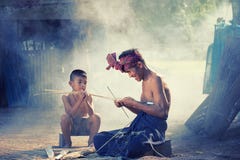 Thailand Father and son are working hand made Basket bamboo or f stock photo Thailand Father and son are working hand made Basket bamboo or f stock photo