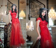 The Beautiful Girl In A Long Red Dress Posing In A Vintage Scene. Young Beautiful Woman Wearing A Red Dress In Luxury Scenery Stock Photography