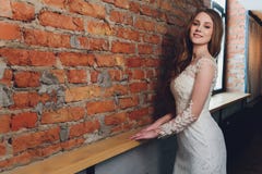 The Beautiful Woman Posing In A Wedding Dress. Royalty Free Stock Photo The Beautiful Woman Posing In A Wedding Dress. Royalty Free Stock Photo