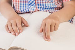 The Blind Boy Is Reading A Book Written On Braille. Royalty Free Stock Image