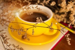 The Blurry Light Design Background Of Yellow Ceramic Coffee Cup Put At The Back Of Dried Flower,vintage And Art Style Stock Photo The Blurry Light Design Background Of Yellow Ceramic Coffee Cup Put At The Back Of Dried Flower,vintage And Art Style Stock Photo