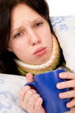The Diseased Girl Lying In Bed, Drinking Tea Royalty Free Stock Image