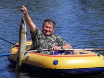 The Fisherman In The Boat With A Pike Stock Photo The Fisherman In The Boat With A Pike Stock Photo