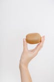 The Girl Holds The Kiwi. A Young Woman Holds A Kiwi In Her Hands. Royalty Free Stock Photo The Girl Holds The Kiwi. A Young Woman Holds A Kiwi In Her Hands. Royalty Free Stock Photo
