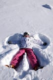 The Girl Lies On Snow. Snow Angel Royalty Free Stock Photo