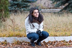 The Girl Sits In A Jacket In The Autumn In Park Stock Images