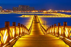 The Golden Wooden Trestle On The Lake In Night Stock Image